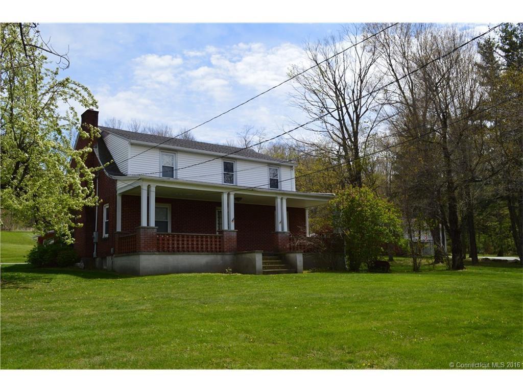 a front view of house with a garden