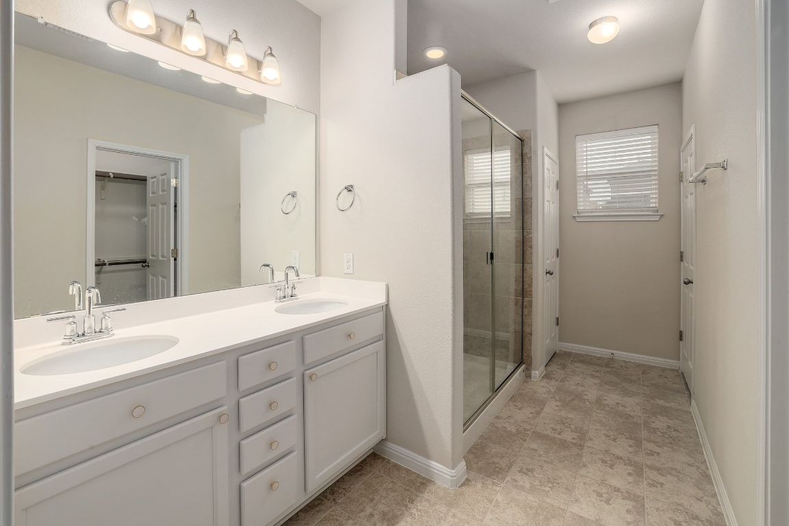 10709 Blacket Drive Austin, TX 78747 - Photo 13 of 27 a spacious bathroom with a double vanity sink mirror and double