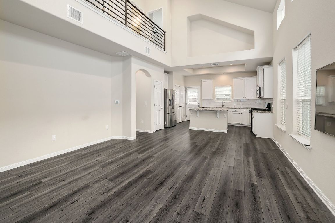 10709 Blacket Drive Austin, TX 78747 - Photo 5 of 27 a large kitchen with cabinets wooden floor and stainless steel appliances