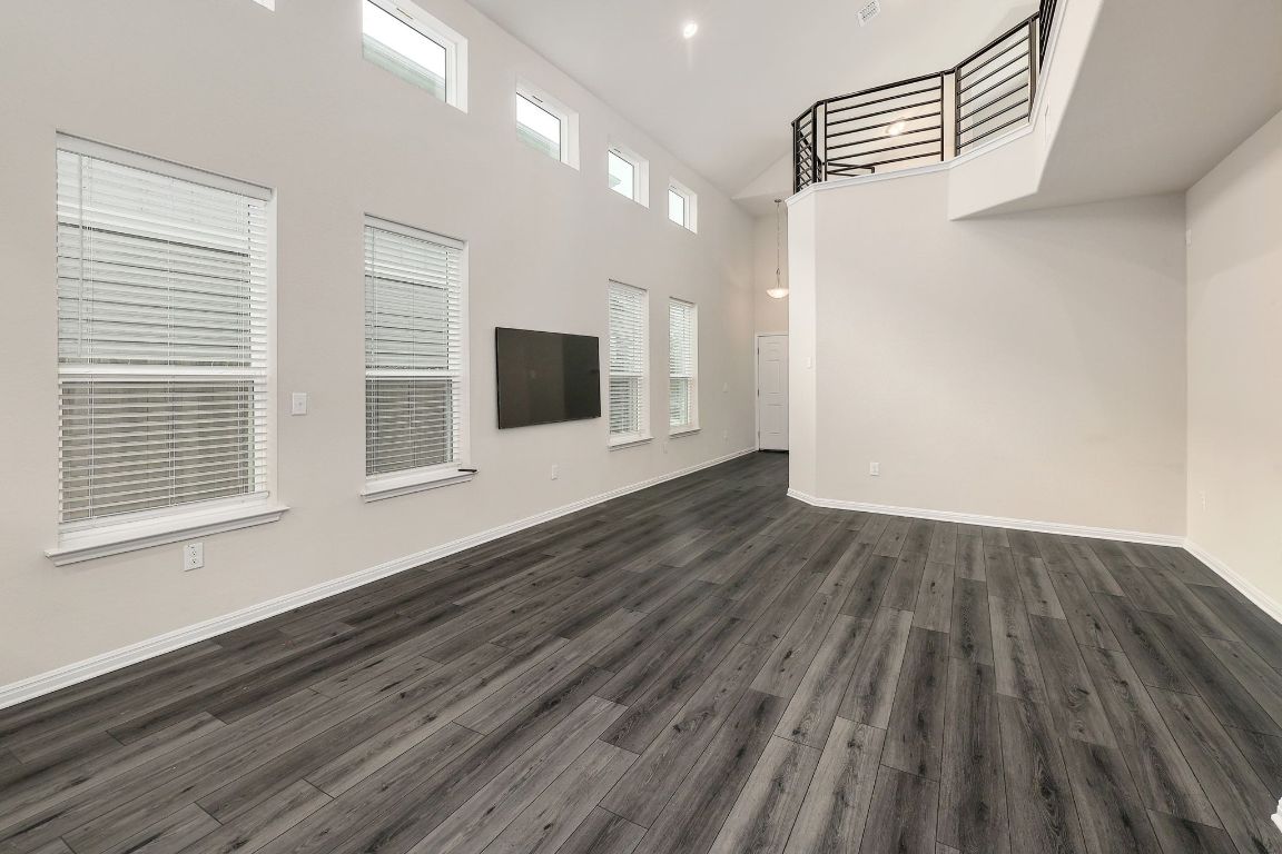 10709 Blacket Drive Austin, TX 78747 - Photo 6 of 27 a view of an empty room with wooden floor and a window
