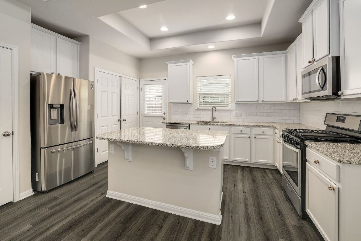 10709 Blacket Drive Austin, TX 78747 - Photo 8 of 27 a kitchen with stainless steel appliances a refrigerator sink and microwave