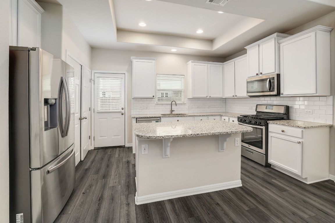 10709 Blacket Drive Austin, TX 78747 - Photo 10 of 27 a kitchen with stainless steel appliances a refrigerator sink and microwave