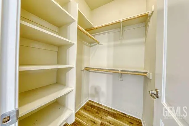 a view of walk in closet with empty racks