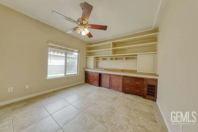 a room with natural light cabinets and appliances