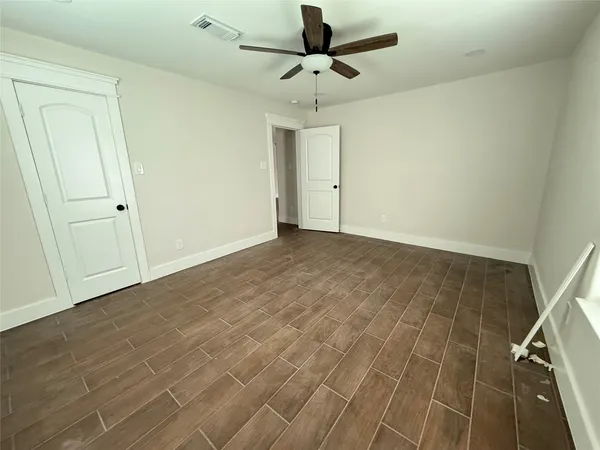 a view of a livingroom with a ceiling fan and window