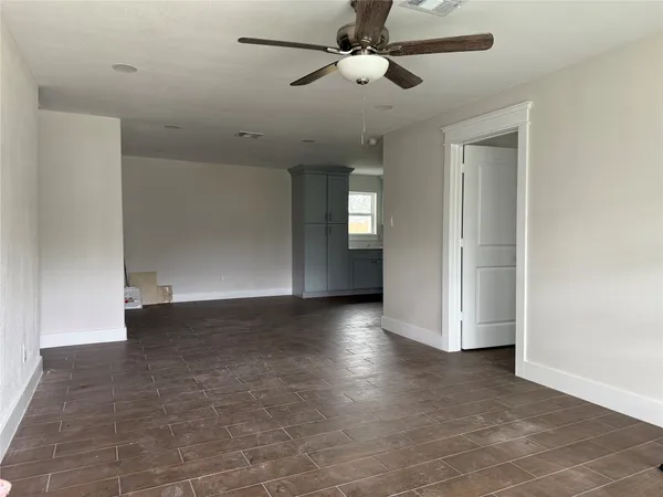 a view of a livingroom with a ceiling fan and window