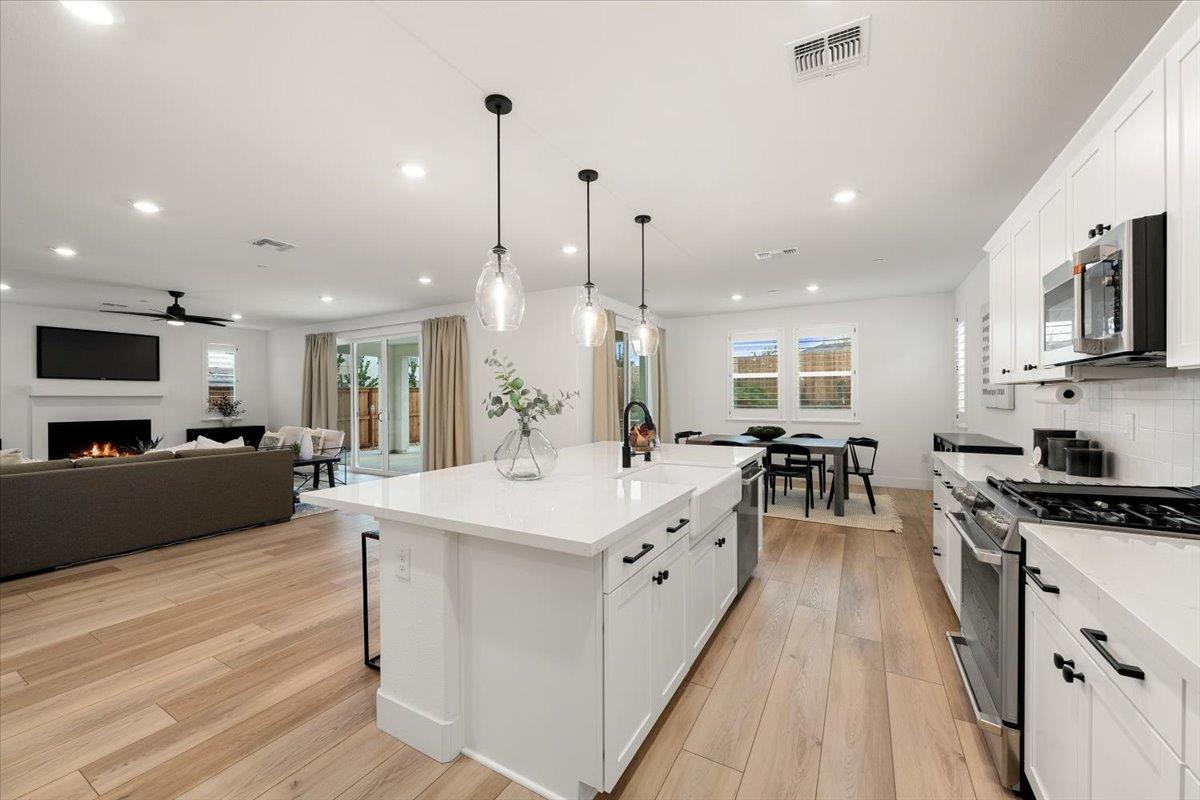 280 Vectra Court Roseville, CA 95747 - Photo 14 of 84 a large kitchen with stainless steel appliances kitchen island granite countertop a large center island attached withe living room