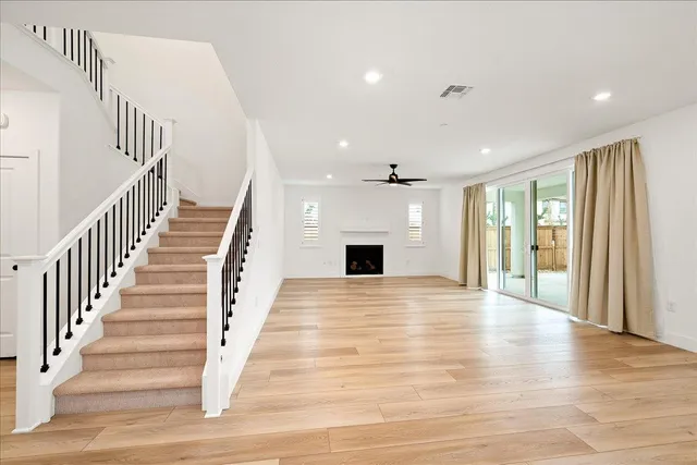 a kitchen with stainless steel appliances kitchen island a refrigerator sink and cabinets