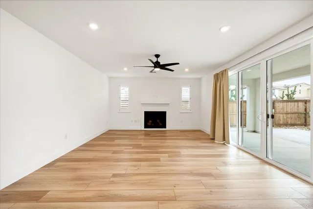 a large kitchen with stainless steel appliances kitchen island a large counter top a sink a stove and a refrigerator