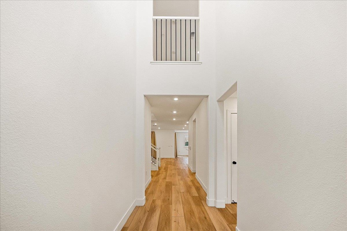 280 Vectra Court Roseville, CA 95747 - Photo 25 of 84 a view of a hallway with wooden floor and a bathroom