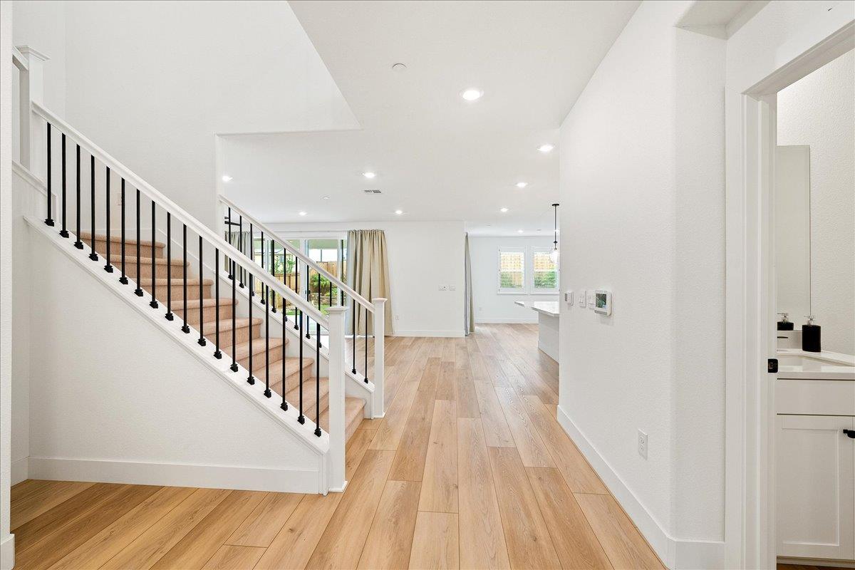 280 Vectra Court Roseville, CA 95747 - Photo 29 of 84 a view of a hallway with wooden floor and staircase
