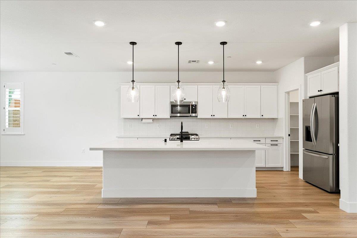 280 Vectra Court Roseville, CA 95747 - Photo 35 of 84 a view of a kitchen with kitchen island a sink stainless steel appliances and cabinets