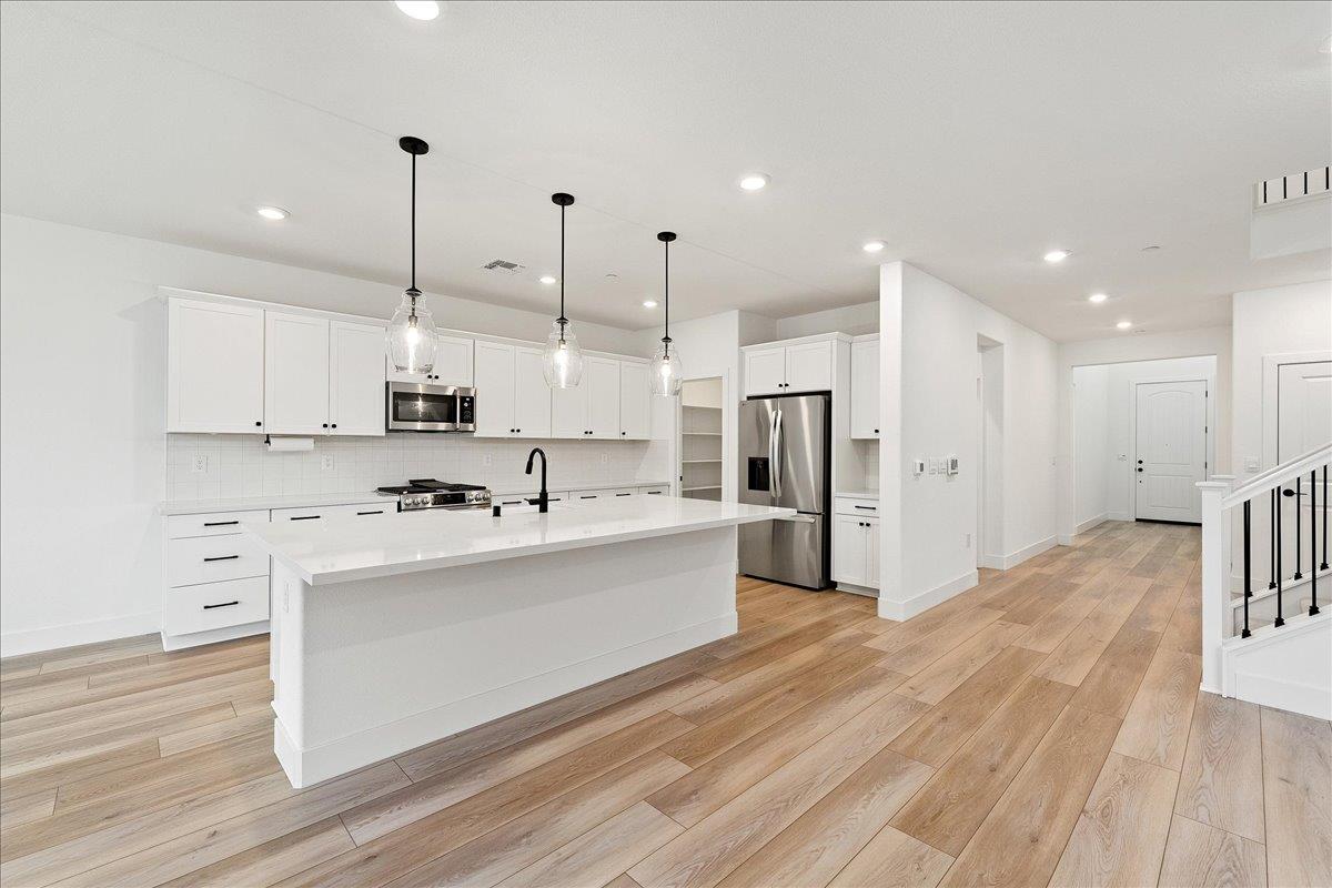 280 Vectra Court Roseville, CA 95747 - Photo 36 of 84 a kitchen with stainless steel appliances kitchen island a refrigerator sink and cabinets