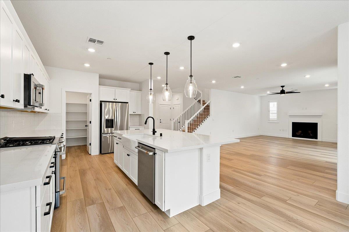 280 Vectra Court Roseville, CA 95747 - Photo 37 of 84 a large kitchen with stainless steel appliances kitchen island a large counter top a sink a stove and a refrigerator