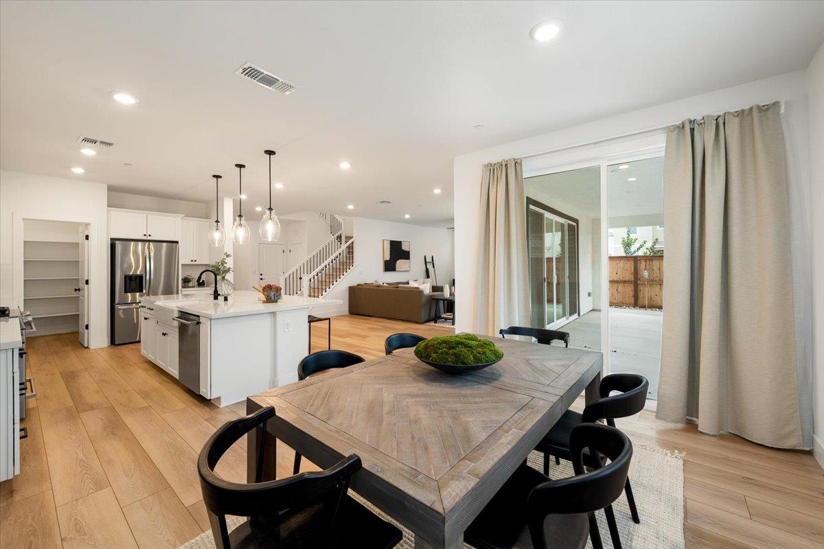 280 Vectra Court Roseville, CA 95747 - Photo 5 of 84 a kitchen with a table chairs stove and wooden floor