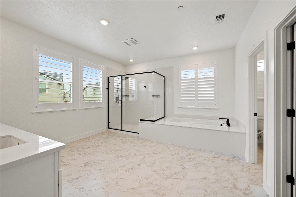 280 Vectra Court Roseville, CA 95747 - Photo 52 of 84 a spacious bathroom with a large tub shower and windows