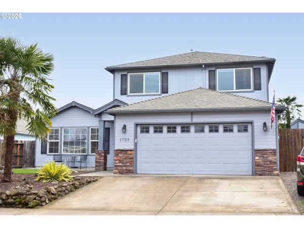 a front view of a house with a garden and plants