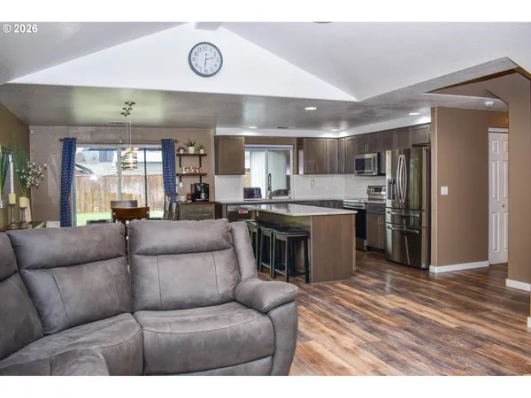a living room with a couch and a view of kitchen