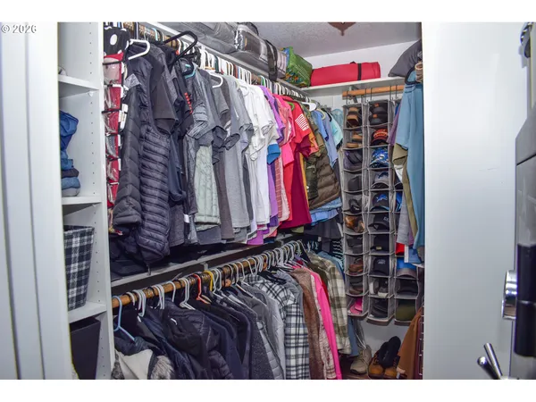 a bedroom with a bed and a painting on the wall