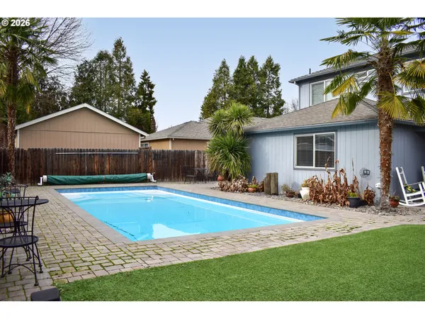 a view of a house with swimming pool and sitting area