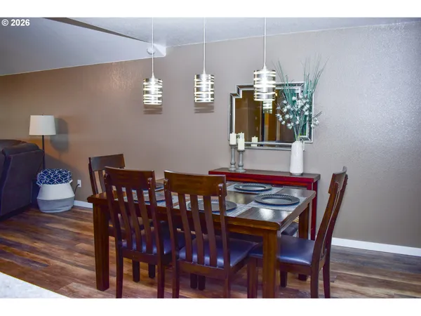 a kitchen with a table chairs refrigerator and microwave
