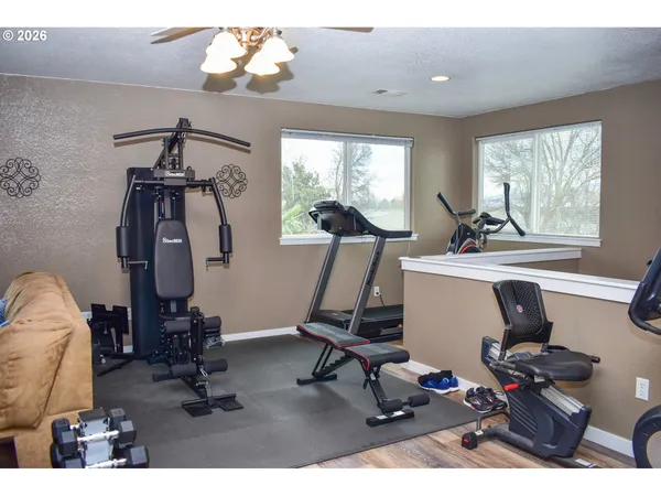 a vase of flowers sitting on a table with a potted plant