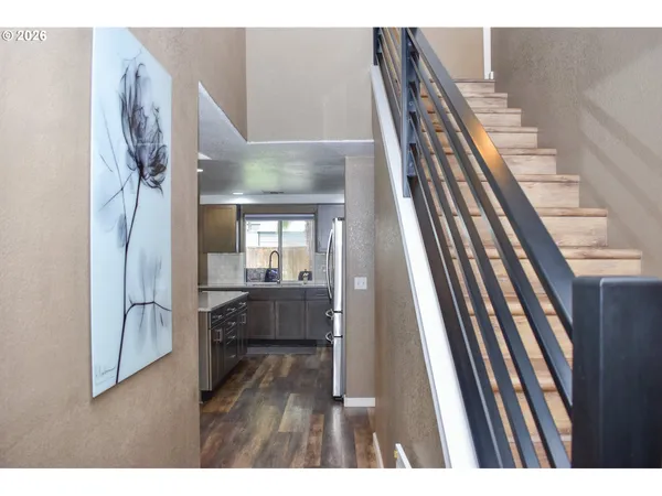 a view of entryway and hall with wooden floor