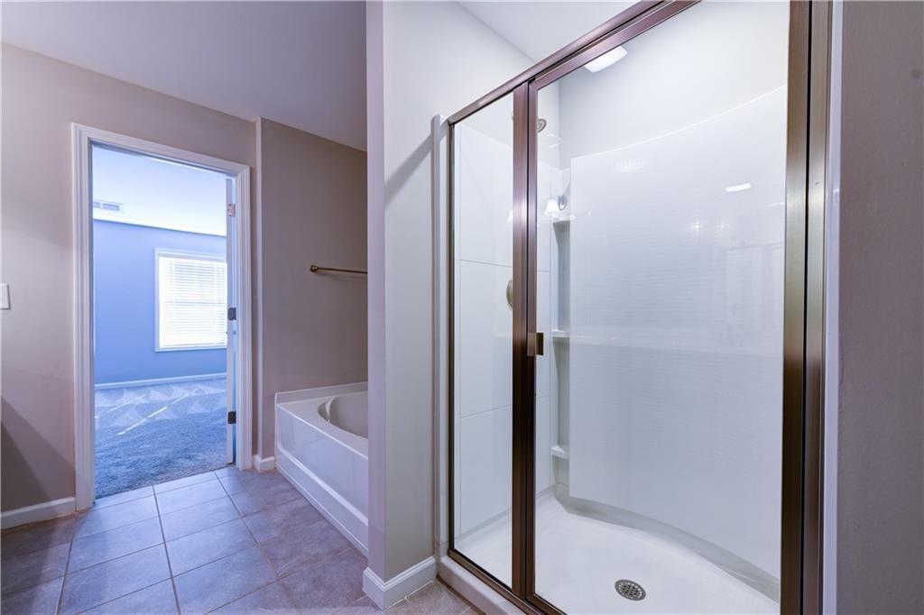1226 Fischer Trace Cumming, GA 30041 - Photo 17 of 24 a bathroom with a bathtub and a shower