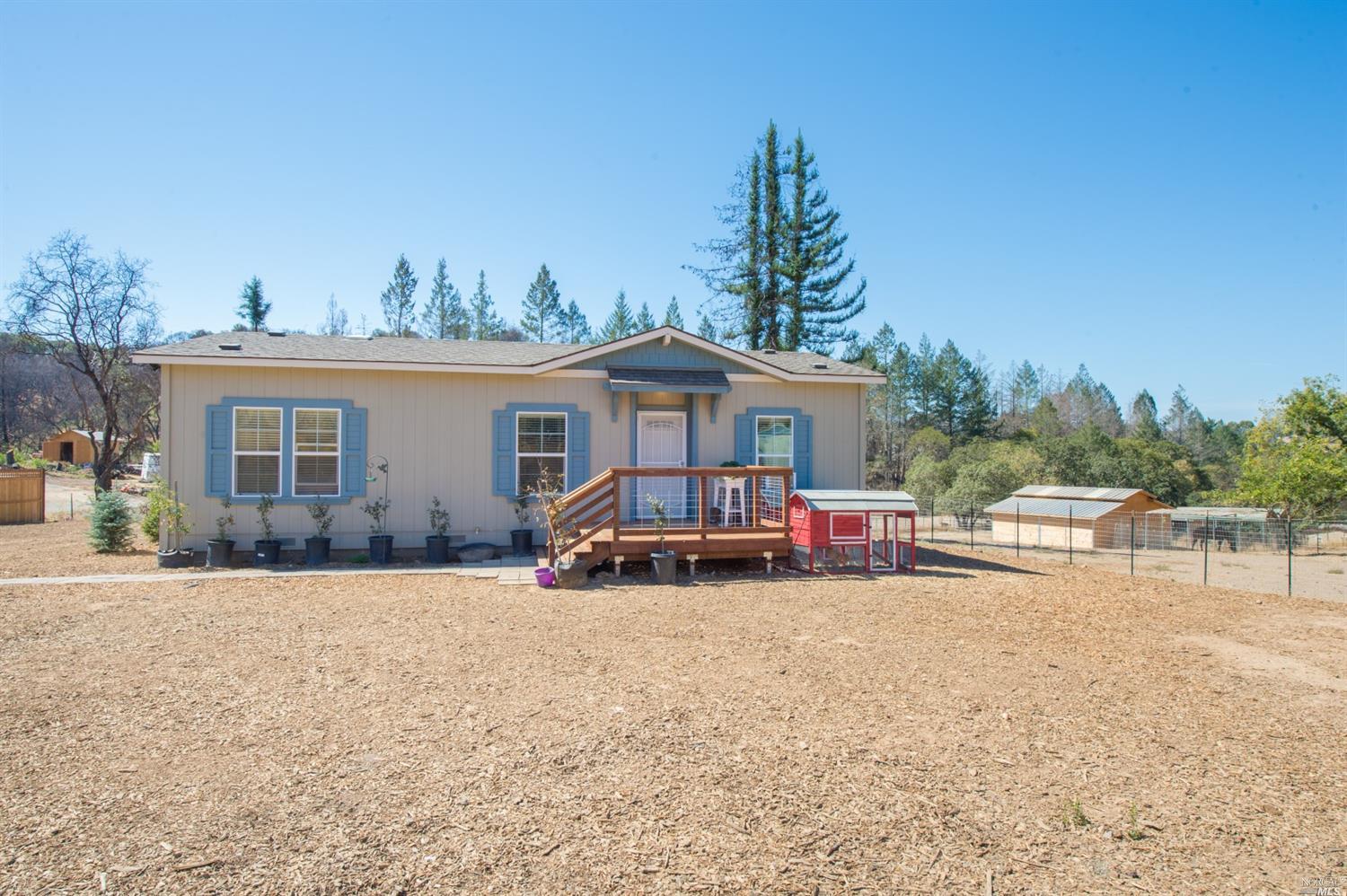 a view of a house with a yard and sitting area