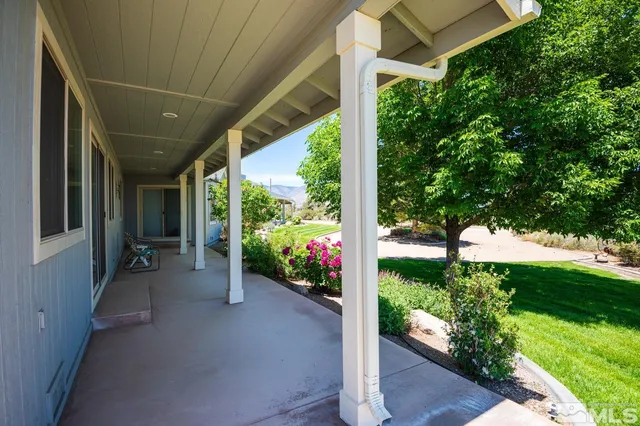 a view of a porch with furniture and yard