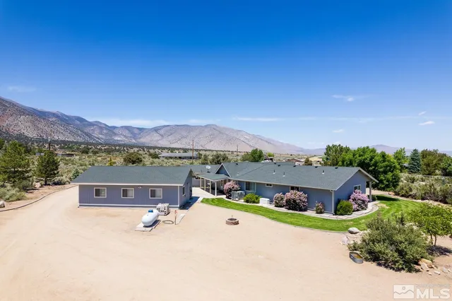 an aerial view of a house with outdoor space