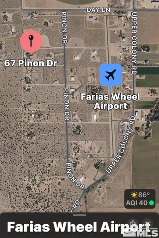 a view of swimming pool with lawn chairs and plants