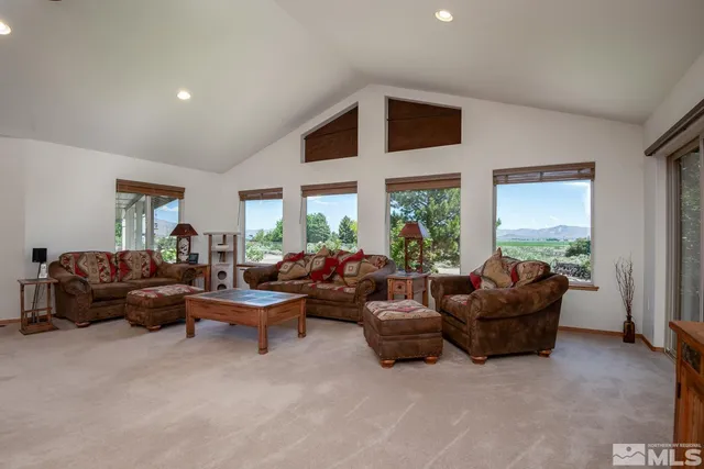 a living room with furniture and a floor to ceiling window
