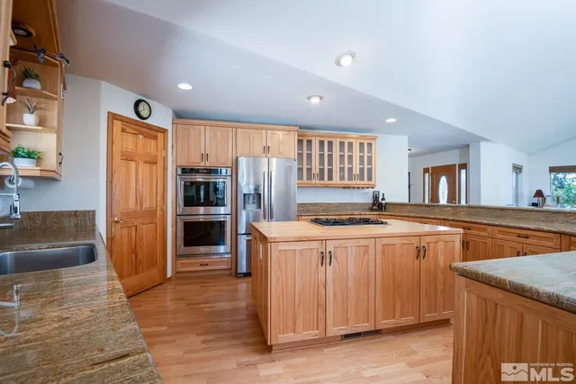 a kitchen with stainless steel appliances granite countertop a stove and a refrigerator