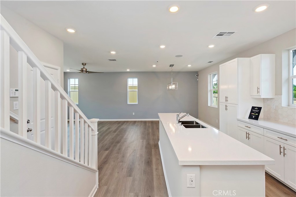 7179 Rindle Lane Riverside, CA 92503 - Photo 11 of 21 a view of a kitchen with kitchen island a sink stainless steel appliances and cabinets