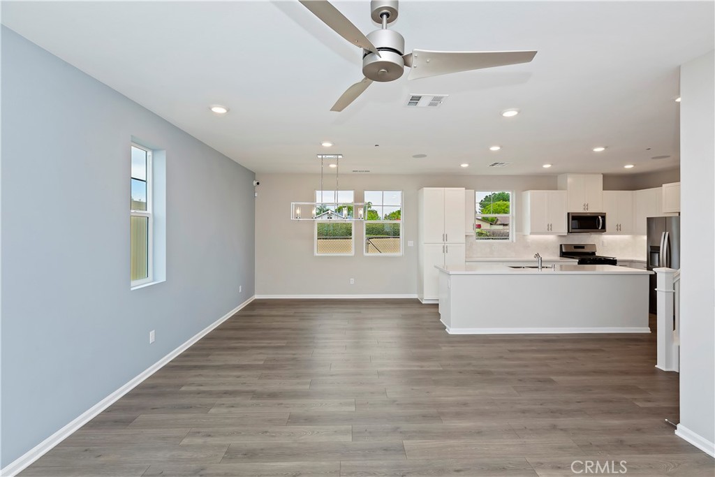 7179 Rindle Lane Riverside, CA 92503 - Photo 17 of 21 a view of kitchen with kitchen island stainless steel appliances wooden floor and window