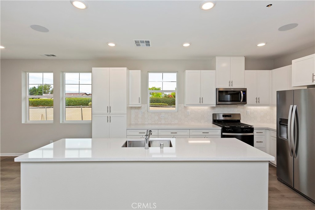 7179 Rindle Lane Riverside, CA 92503 - Photo 4 of 21 a kitchen with kitchen island a sink appliances a window and a counter top space