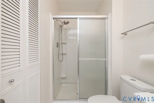 a bathroom with a toilet and a shower