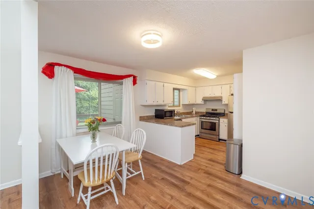a kitchen with a sink cabinets and wooden floor