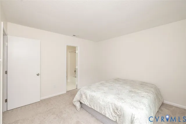 a view of a bedroom with a window and closet