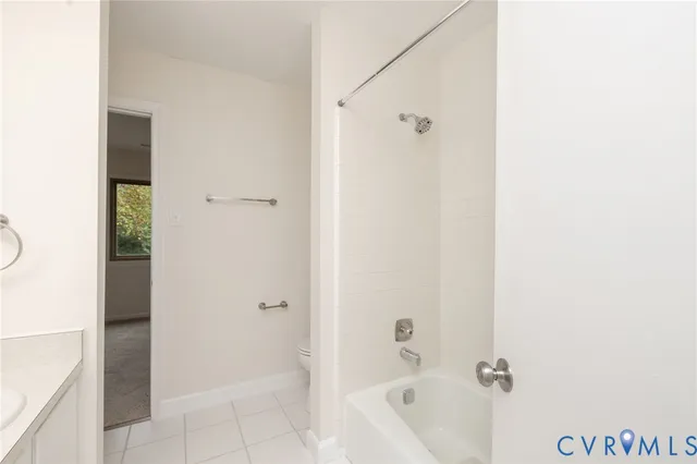 a bathroom with a shower curtain and a toilet