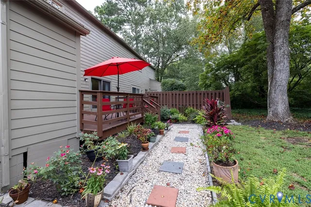 a view of small garden with wooden fence