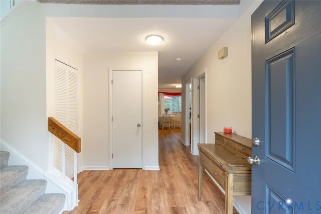 a view of hallway with wooden floor