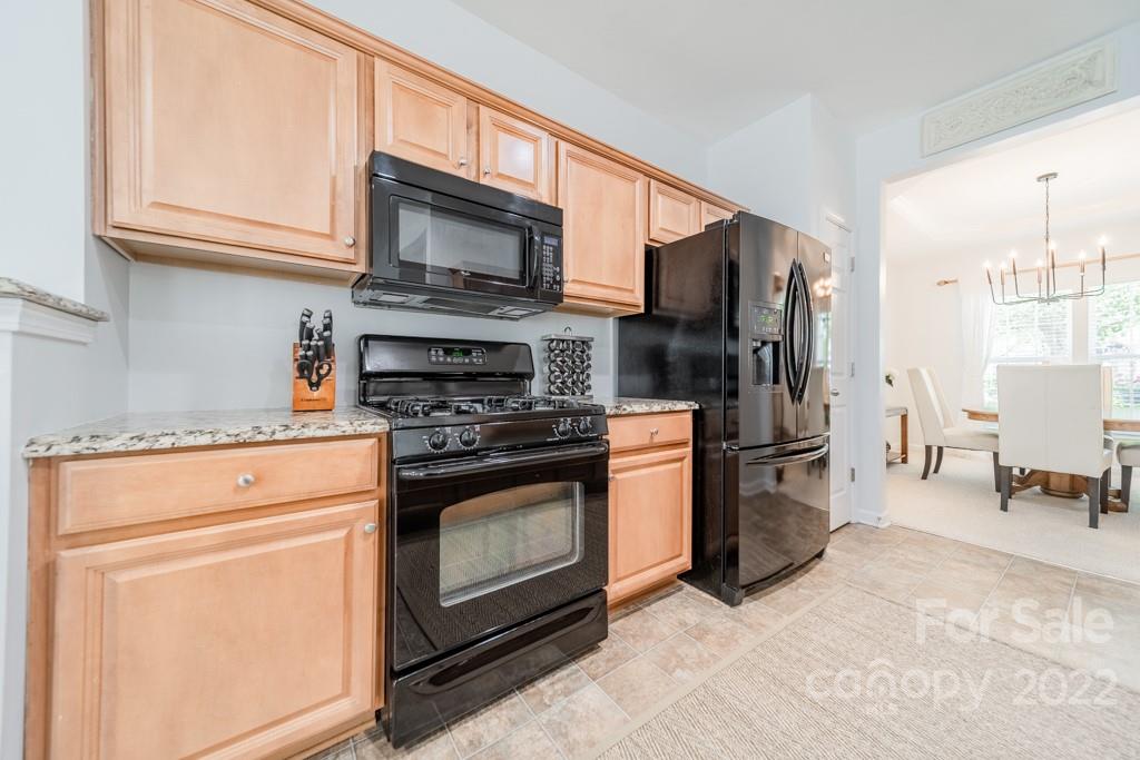 194 Snead Road Fort Mill, SC 29715 - Photo 11 of 43 a kitchen with stainless steel appliances granite countertop a stove microwave and refrigerator