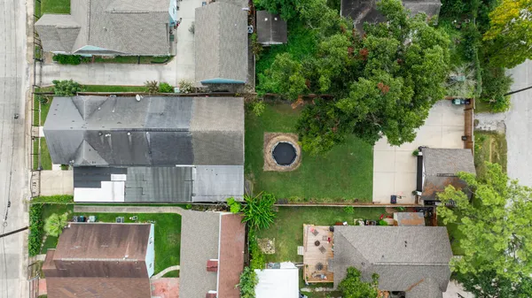 an aerial view of a house with a yard