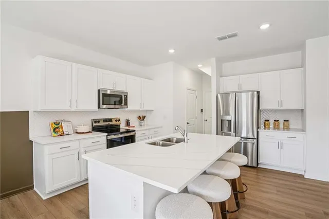 a living room with furniture and kitchen view