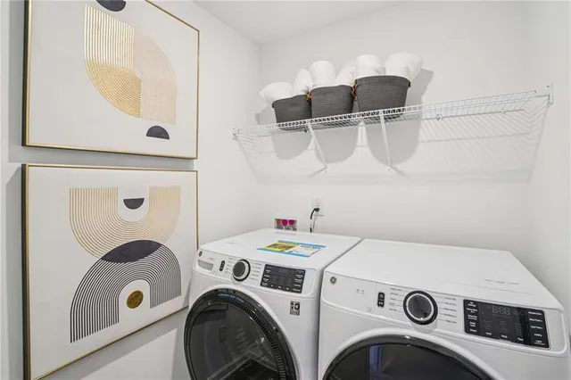 a room with a table chairs and a refrigerator