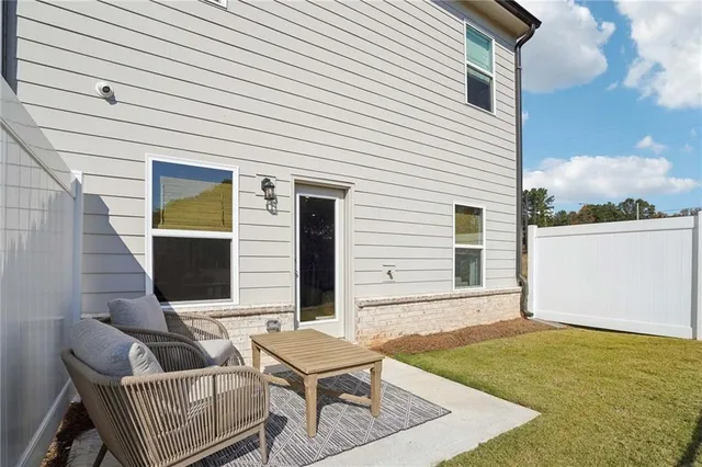 a view of a kitchen with furniture and a refrigerator