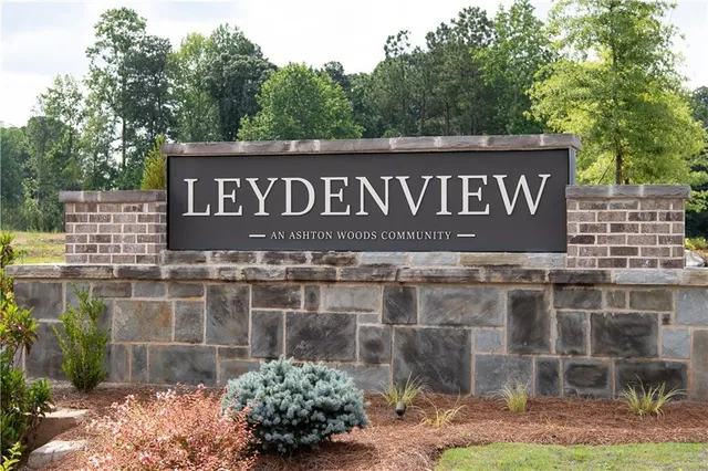 a kitchen with granite countertop a sink stove and cabinets