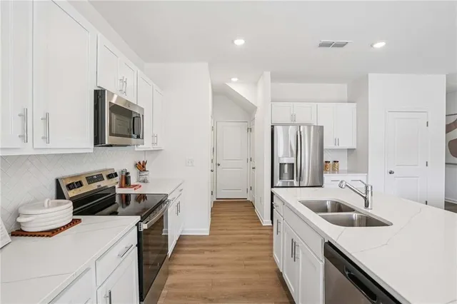 a kitchen that has a sink and a stove top oven